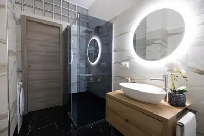 a bathroom with a sink and a shower with a mirror at City Vibe Red Rose in Rome