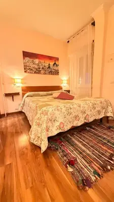 a bedroom with a large bed and a rug at Casa Lory in Rome