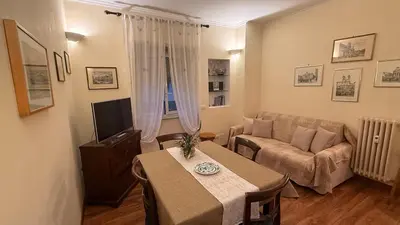 a living room with a table and a couch at Casa Lory in Rome
