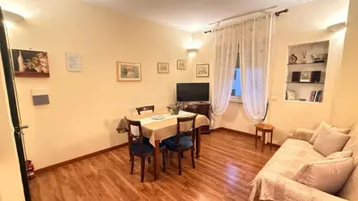 a living room with a table and a couch at Casa Lory in Rome