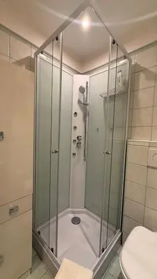 a shower with a glass door in a bathroom at Casa Lory in Rome