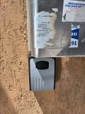 a cell phone sticking out of the side of a wall at Bilocale in Via degli Orti Variani in Rome