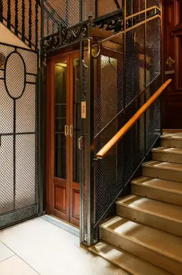 an entrance to a building with a wooden door and stairs at Colosseum window 1800-Romantic apartment Rome in Rome