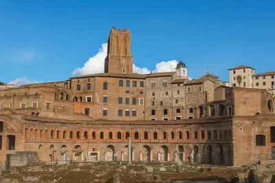 a large brick building with a tower on top at Colosseum window 1800-Romantic apartment Rome in Rome