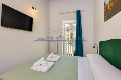 a bedroom with a bed with two white towels at DEB Suite Campo de' fiori nel cuore di Roma in Rome