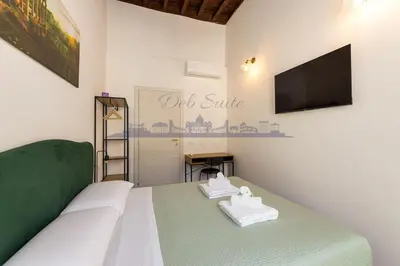 a bedroom with a bed with two towels on it at DEB Suite Campo de' fiori nel cuore di Roma in Rome