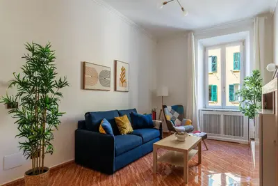 a living room with a blue couch and a table at CS Beautiful San Giovanni Apt in Rome