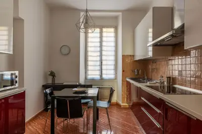 a kitchen with a table and a dining room at CS Beautiful San Giovanni Apt in Rome