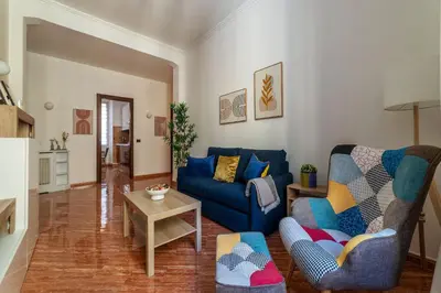 a living room with a blue couch and a table at CS Beautiful San Giovanni Apt in Rome