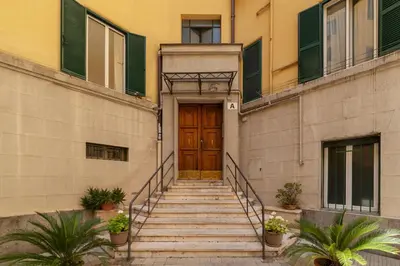 a set of stairs leading to a wooden door at CS Beautiful San Giovanni Apt in Rome