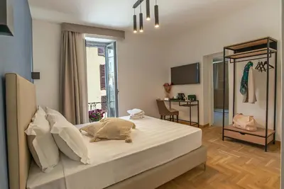 a bedroom with a large white bed in a room at Essence Guesthouse in Rome