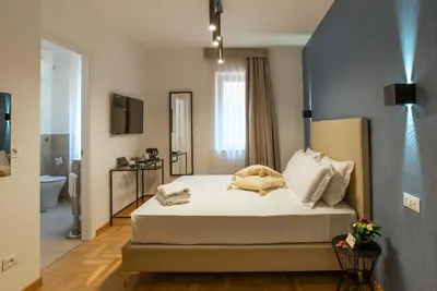 a bedroom with a bed and a bathroom at Essence Guesthouse in Rome