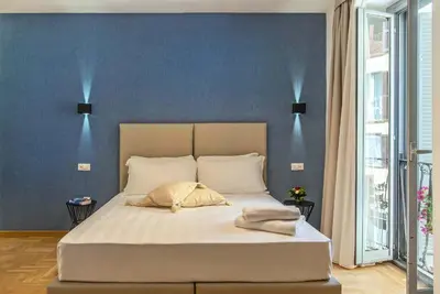 a bedroom with a bed with two lights above it at Essence Guesthouse in Rome