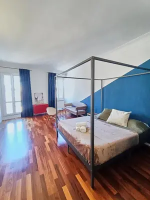 a bedroom with a canopy bed and a desk at Casa Lucrezia in Rome