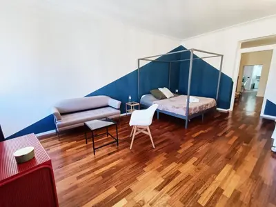 a living room with a bed and a couch at Casa Lucrezia in Rome