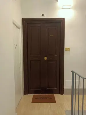 a brown door with a welcome mat in front of it at Casa Lucrezia in Rome