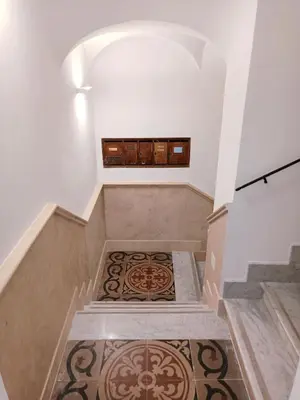 a set of stairs with a rug on the floor at Casa Lucrezia in Rome