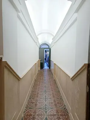 a hallway in a building with a tile floor at Casa Lucrezia in Rome