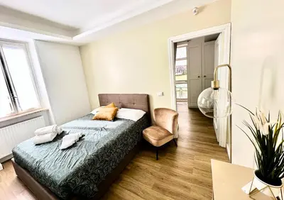a bedroom with a bed and a chair at Casa Happya - Metro A - Central Rome in Rome