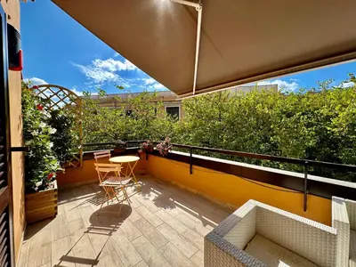 a patio with a table and chairs on a balcony at Casa Happya - Metro A - Central Rome in Rome
