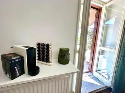 a shelf with wine bottles on it next to a window at Casa Happya - Metro A - Central Rome in Rome