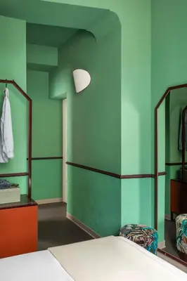 a man and woman standing on a balcony looking at their cell phones at Barberini Retreat Boutique Hotel in Rome