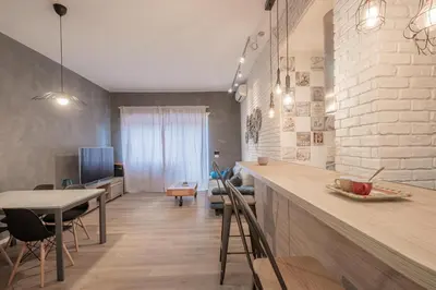 a kitchen and dining room with a counter and a table at BBB House Saint Peter in Rome