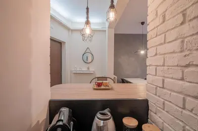 a kitchen with a wooden counter and a brick wall at BBB House Saint Peter in Rome