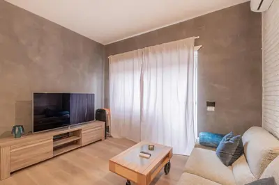 a living room with a couch and a flat screen tv at BBB House Saint Peter in Rome