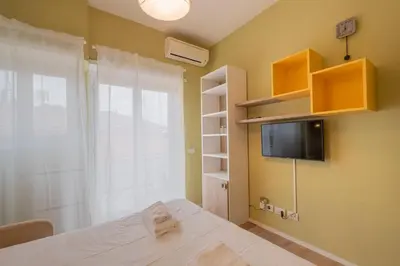 a bedroom with a bed and a window and a tv at BBB House Saint Peter in Rome