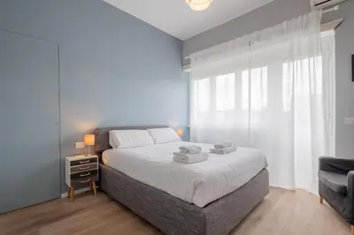 a bedroom with a bed and a large window at BBB House Saint Peter in Rome