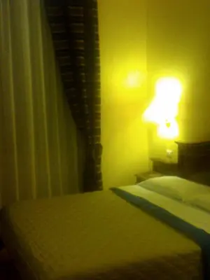 a bedroom with a bed with a lamp on it at Pitagora House in Rome