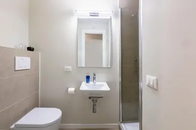 a bathroom with a toilet and a sink and a shower at Casa Gracchi by Hili in Rome