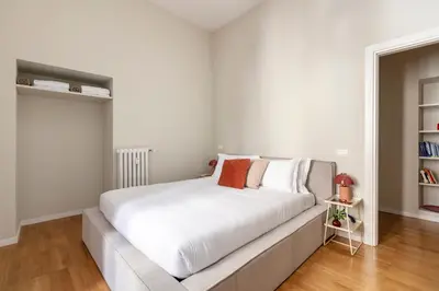 a bedroom with a large bed with white sheets at Casa Gracchi by Hili in Rome