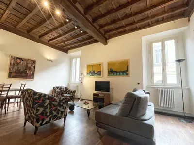 a living room with a couch and chairs and a table at DeLUX Apartment in Rome