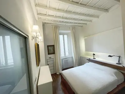 a bedroom with a white bed and a window at DeLUX Apartment in Rome