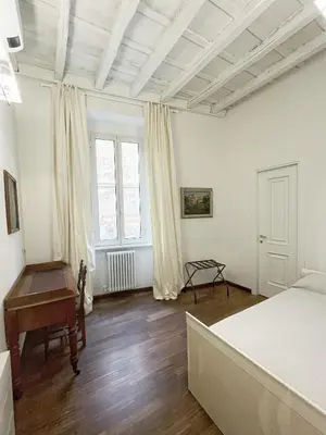 a bedroom with a bed and a desk in it at DeLUX Apartment in Rome