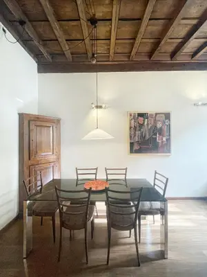 a dining room with a glass table and chairs at DeLUX Apartment in Rome