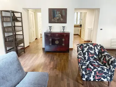 a living room with a couch and a chair at DeLUX Apartment in Rome