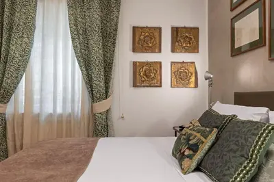 a bedroom with a white bed and a window at Luxurious home of the antiquarian at Spanish Steps in Rome