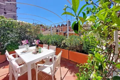 a white table and chairs in a garden at Magical Navona Duplex With Terrace by Halldis in Rome