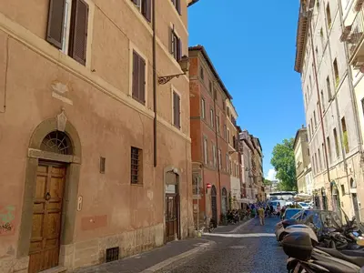 a street with buildings and cars parked on a cobblestone street at Magical Navona Duplex With Terrace by Halldis in Rome