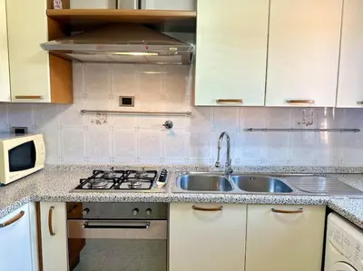 a kitchen with a sink and a stove at Capa's Boccea in Rome