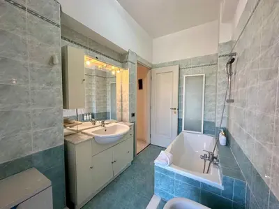 a bathroom with a tub and a sink and a bath tub at Capa's Boccea in Rome