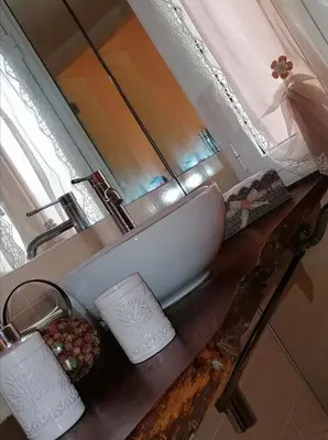a sink on a wooden counter in a bathroom at Borgo Pio 51 Apartment Vatican in Rome