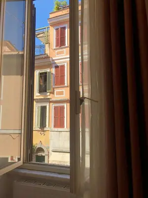 an open window with a view of a building at Borgo Pio 51 Apartment Vatican in Rome