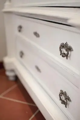 a white dresser with metal knobs on it at Borgo Pio 51 Apartment Vatican in Rome