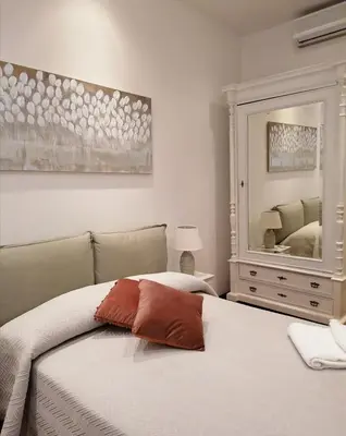 a bedroom with a bed and a large mirror at Borgo Pio 51 Apartment Vatican in Rome