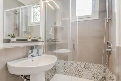 a white bathroom with a sink and a shower at Sales in Trastevere in Rome