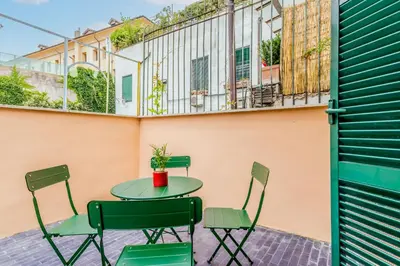 a patio with a table and chairs on a balcony at Sales in Trastevere in Rome